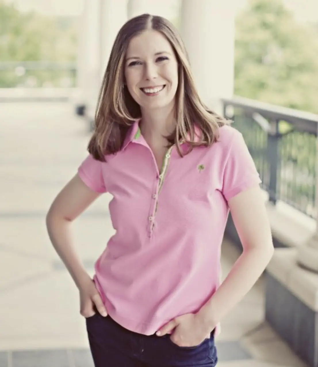 Smiling Woman Wearing a Pink Collared Shirt